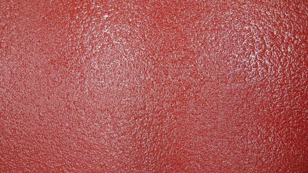 Textura abstracta roja con relieve granulado