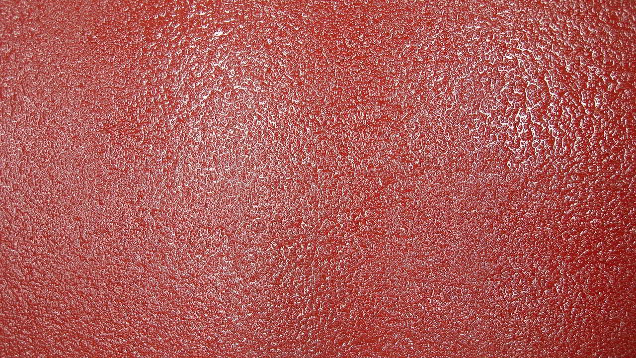 Textura abstracta roja con relieve granulado