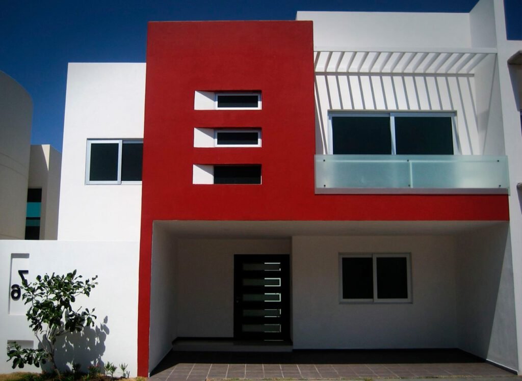Fachada de casa moderna con detalles rojos y blancos